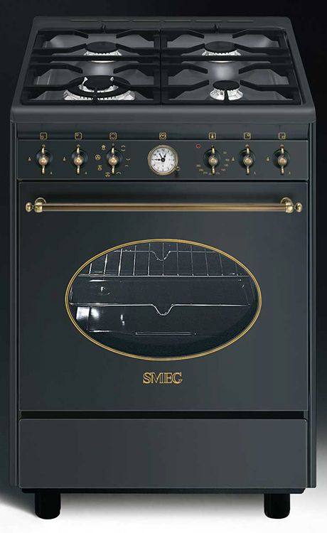 a black stove top oven with gold trimmings and knobs on the front