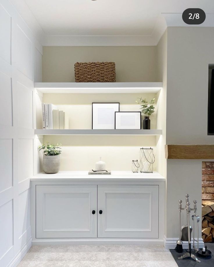 there is a shelf with books and pictures on it in the living room next to a fire place