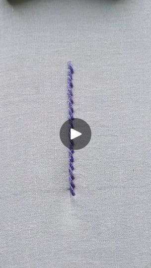 a piece of cloth that has been stitched with purple thread