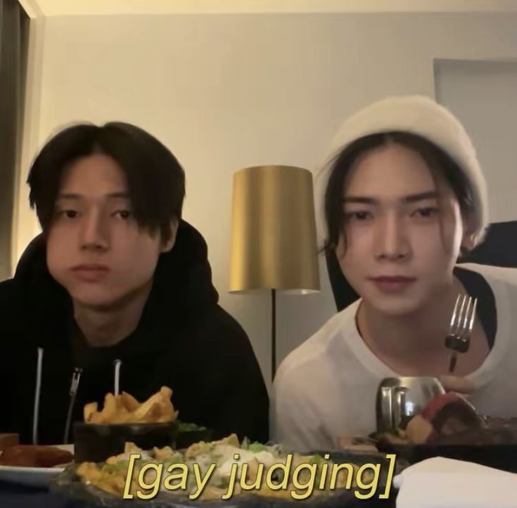 two people sitting at a table with food in front of them and the caption says lazy judging