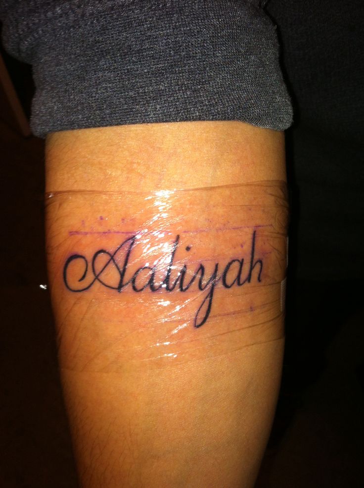 a person with a tattoo on their leg that reads aldinah and has the word aldinah written in cursive writing