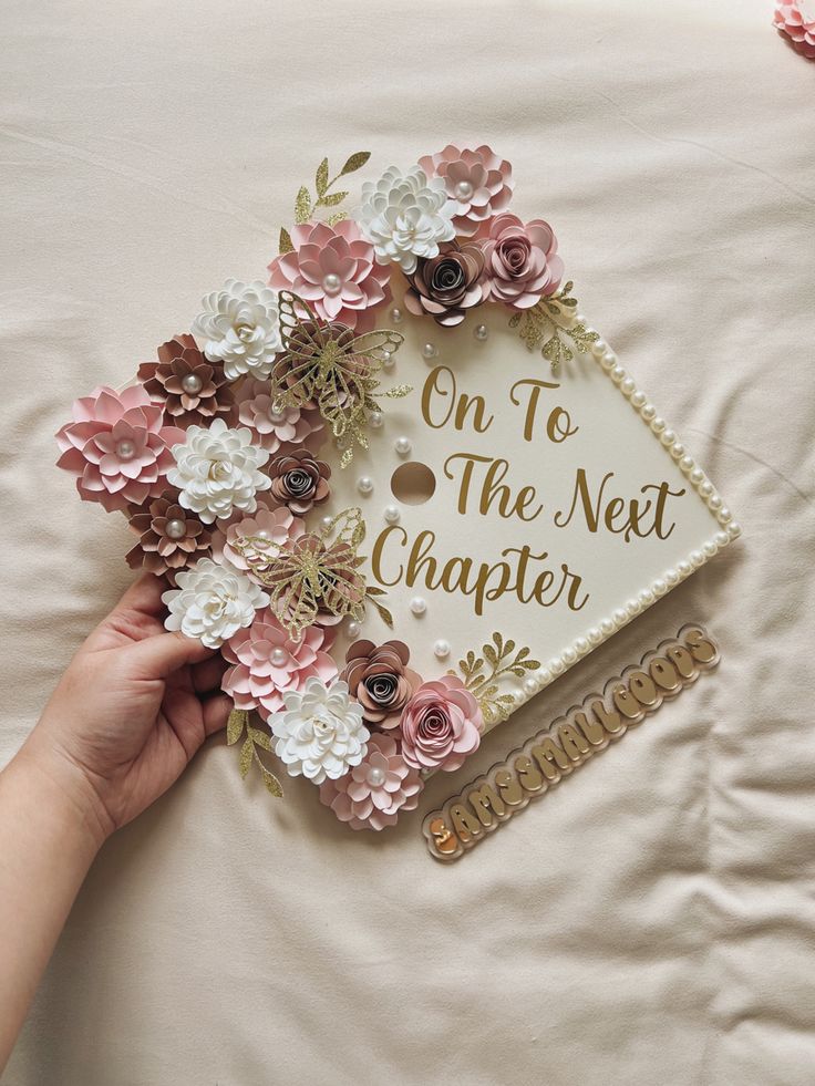 someone is placing flowers on top of a graduation cap that says, on to the next charter