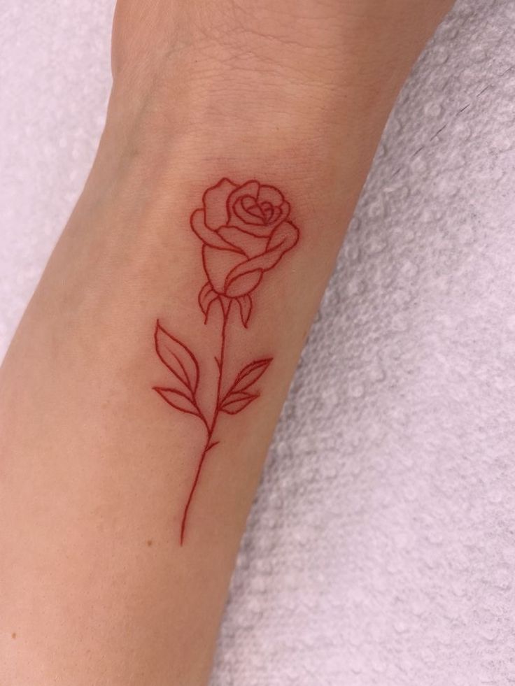 a small rose tattoo on the wrist