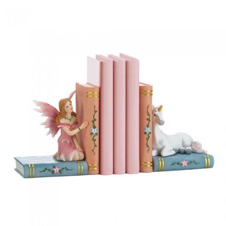 a figurine sitting on top of two books with an angel and unicorn next to it