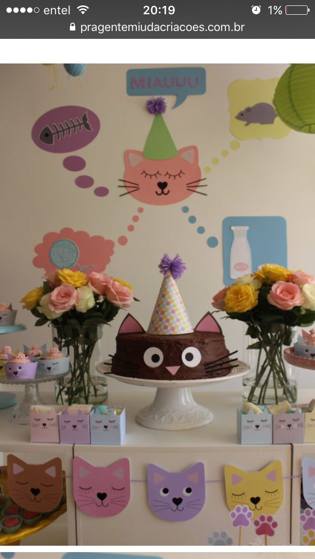 a table topped with cake and flowers on top of a white tablecloth covered in paper