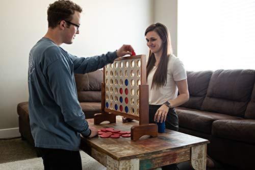 a man and woman playing giant checkers on a coffee table in the living room