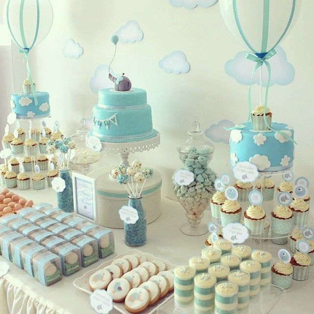 a table topped with lots of cakes and cupcakes