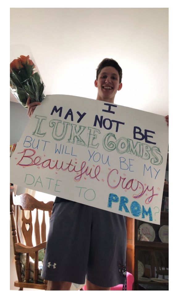 a man holding up a sign that says i may not be sorry to my wife, but will you be my beautiful crazy date to prom