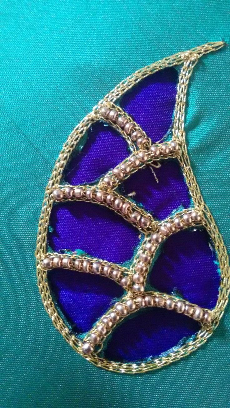 a brooch that is sitting on top of a blue cloth