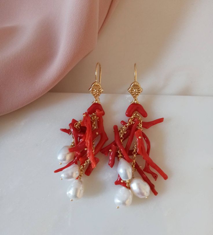 925 Sterling Silver Earrings made with: - Natural Coral branches, red color; - Freshwater Pearls, white color; - Gold plated 925 Sterling Silver hooks with little fishes. Lenght : 6,5 cm / 2,56 inches * SHIPPING * Your order will be shipped within 1-3 business days from your purchase. You can choose between 2 shipping methods: STANDARD MAIL (NOT TRACEABLE) It is a cheap and fast shipping method, but NOT TRACEABLE. Chapeau Atelier is not responsible for any postal disruptions, delays or losses. R Coral Jewelry With Ear Wire For Gift, Coral Jewelry Gift With Ear Wire, Elegant White Red Coral Jewelry, Handmade White Red Coral Jewelry, Coral Earrings With Ear Wire As Gift, Red Coral Earrings As Gift, Elegant Coral Dangle Earrings, Handmade Coral Earrings In Red Coral, Coral Dangle Earrings