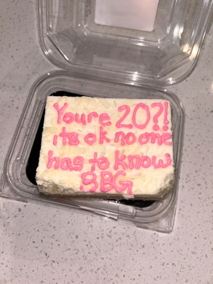 a cake in a plastic container with writing on it