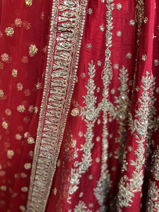 Go all out in this whimsical lehenga, studded with precious mirror, pearl, stone, embroidery work, which is sure to bring out the innate grace and grandeur in you! Color - Crimson Red Fabric & Work Style - - Silk blouse: mirror, pearl, stone, embroidery work. - Soft net lehenga: mirror, pearl, stone, embroidery work. - Soft net dupatta: embroidery work. Details - - Assured quality - Wash care instruction: Dry clean only. - Slight variation in color is possible due to digital photography. Anarkali Sherwani With Mirror Work For Reception, Reception Sherwani With Intricate Embroidery, Anarkali Sherwani With Mirror Work In Chanderi, Festival Sherwani With Dupatta In Chinon, Dabka Work Chinon Sherwani For Reception, Chinon Sherwani With Dabka Work For Reception, Chinon Sherwani With Mirror Work For Festive Occasion, Wedding Sherwani With Dupatta In Chinon, Festival Chinon Sherwani With Dupatta