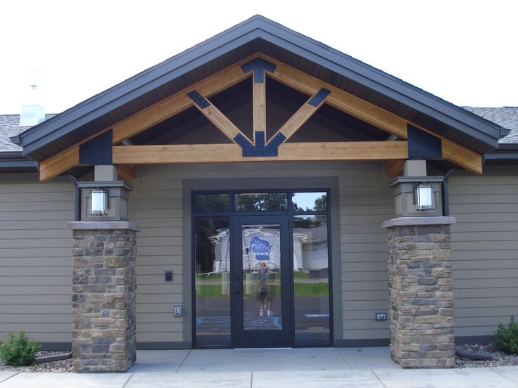 the front entrance to a building with stone pillars