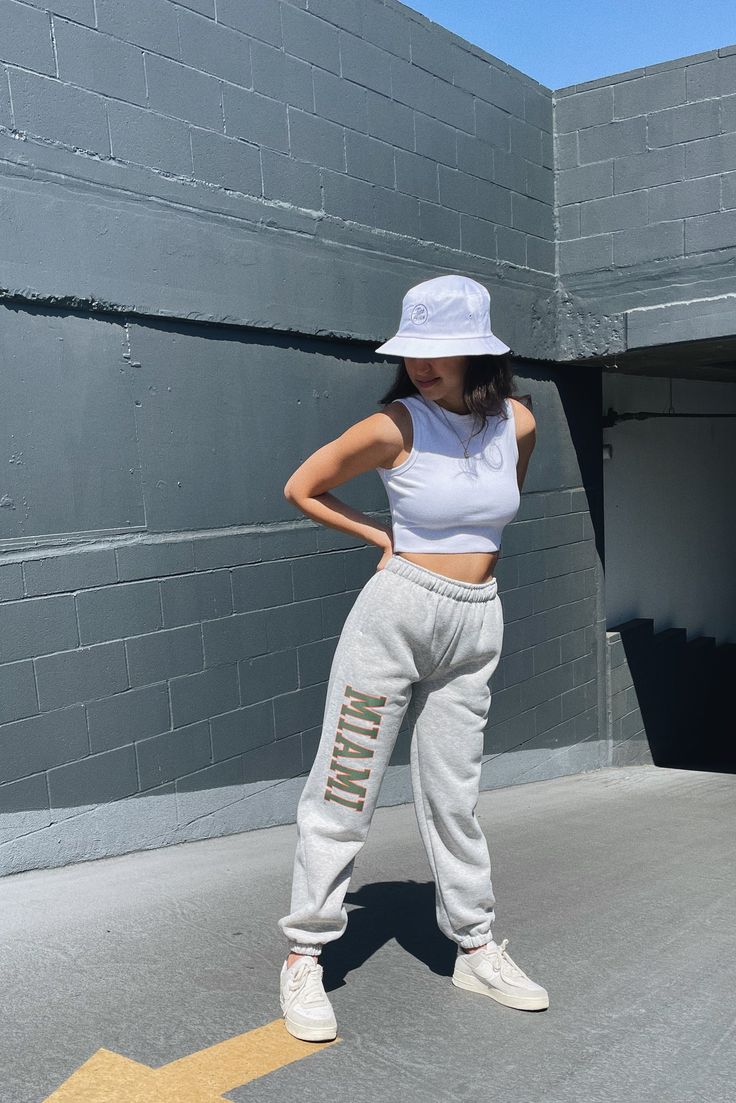 A must have! Stay comfy all season long in the our Miami Basic Sweatpants. These sweatpants feature a high-rise fit, elastic waistband, side pockets, and cuffed ankles. High-rise Elastic waistband Side pockets Cuffed ankles 75% Cotton, 25% Polyester Machine washable P.S. We'd love to see you repping this style! Don't forget to tag us to be featured ♡ *All MTO orders are made specifically for you. Please allow 3-6 business days for order to be processed and shipped. Please note we do not offer re Trendy Sports Sweatpants With Elastic Waistband, Urban Sweats With Elastic Waistband For Streetwear, Urban Style Sweats For Streetwear With Elastic Waistband, Urban Joggers With Letter Print For Loungewear, Fall Urban Sweatpants With Letter Print, Basic Sweatpants With Elastic Waistband For Streetwear, Urban Activewear With Elastic Waistband For Loungewear, White Sweatpants For Sports In Fall, Hip Hop Style Relaxed Fit Joggers For Loungewear