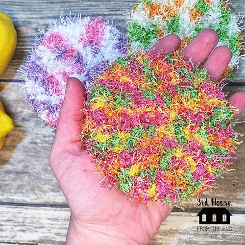 someone is holding some colorful yarn in their hand next to bananas and other things on the table