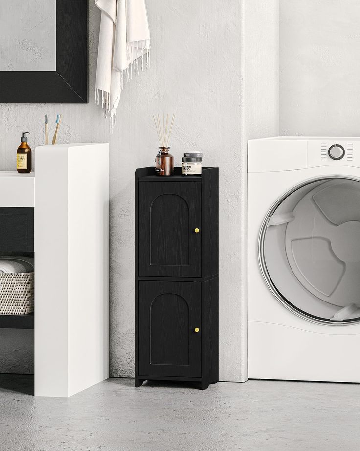 a washer sitting next to a dryer in a bathroom