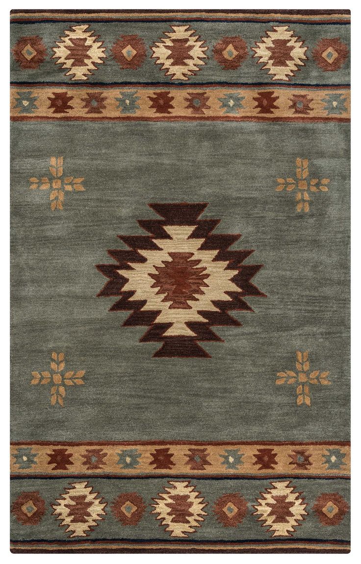 a green rug with brown and tan designs on it