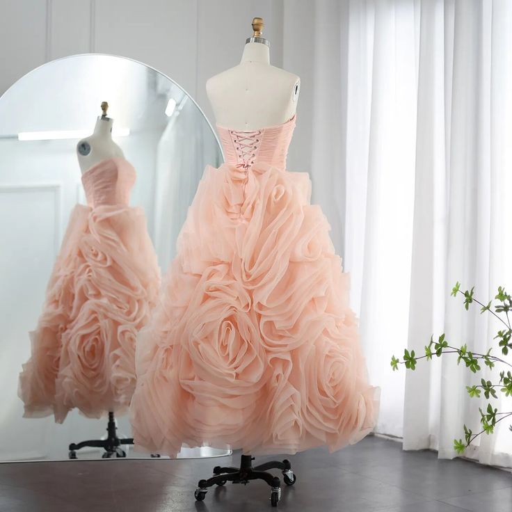 two dresses on mannequins in front of a mirror