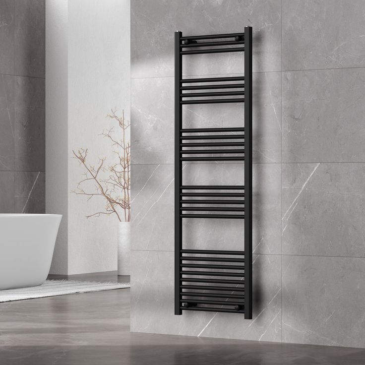 a black towel rack in a bathroom next to a tub