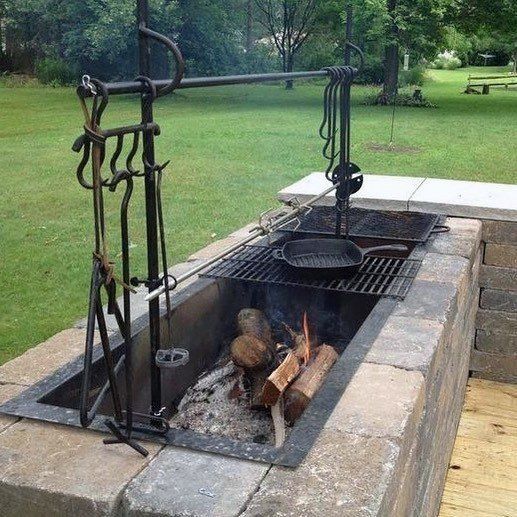 an outdoor fire pit in the middle of a park