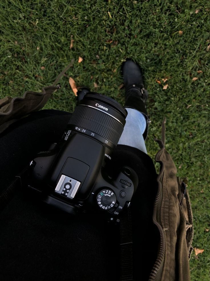 the camera is sitting on someone's back with their feet up in the grass