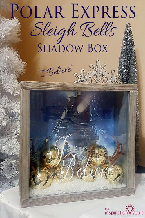 the polar express sleigh bells shadow box is displayed in front of a christmas tree