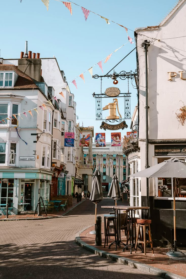 an empty street with tables and chairs on it