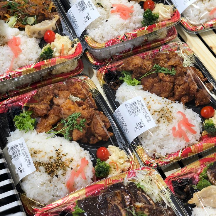 several trays filled with different types of food on top of each other in plastic containers