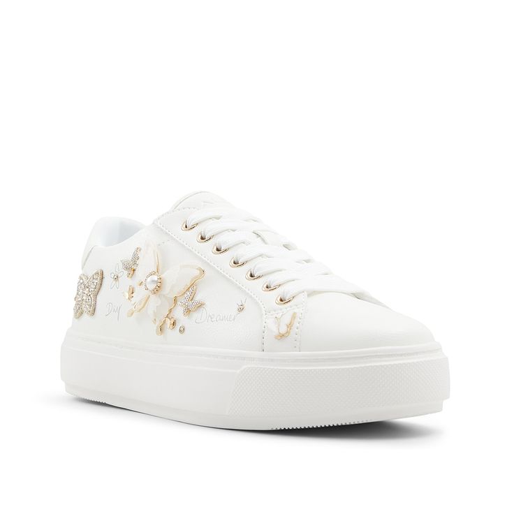 Aldo-Pearlwing Platform Sneaker - Women's Add a fluttering flair to your sporty looks with the Pearlwing sneakers from Aldo. These simple kicks are elevated by sparkling rhinestones and butterfly pin accents.Complete with a platform design for a trendy touch. White Embellished Lace-up Sneakers, Spring White Platform Sneakers With Studded Outsoles, White Platform Sneakers With Studded Outsoles For Spring, Embellished Synthetic Low-top Sneakers, Embellished Low-top Synthetic Sneakers, Sporty Embellished Low-top Sneakers, Sporty Low-top Embellished Sneakers, Embellished Low-top Sneakers For Spring, Sporty Embellished Lace-up Sneakers