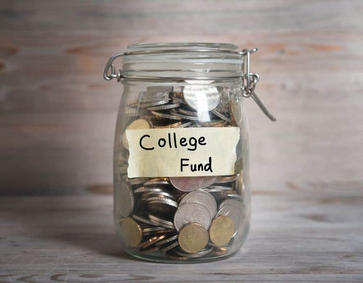 a glass jar filled with coins labeled donations