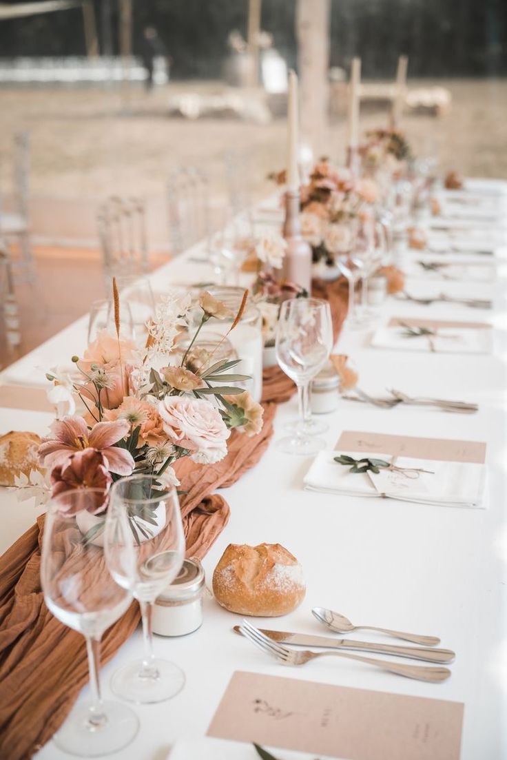 a long table is set with place settings and silverware