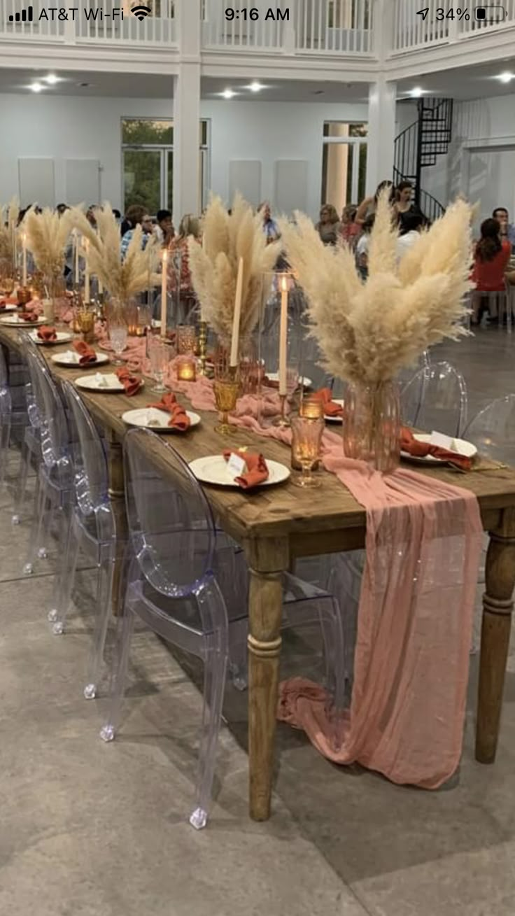 a long table is set up with chairs and place settings for an elegant dinner party