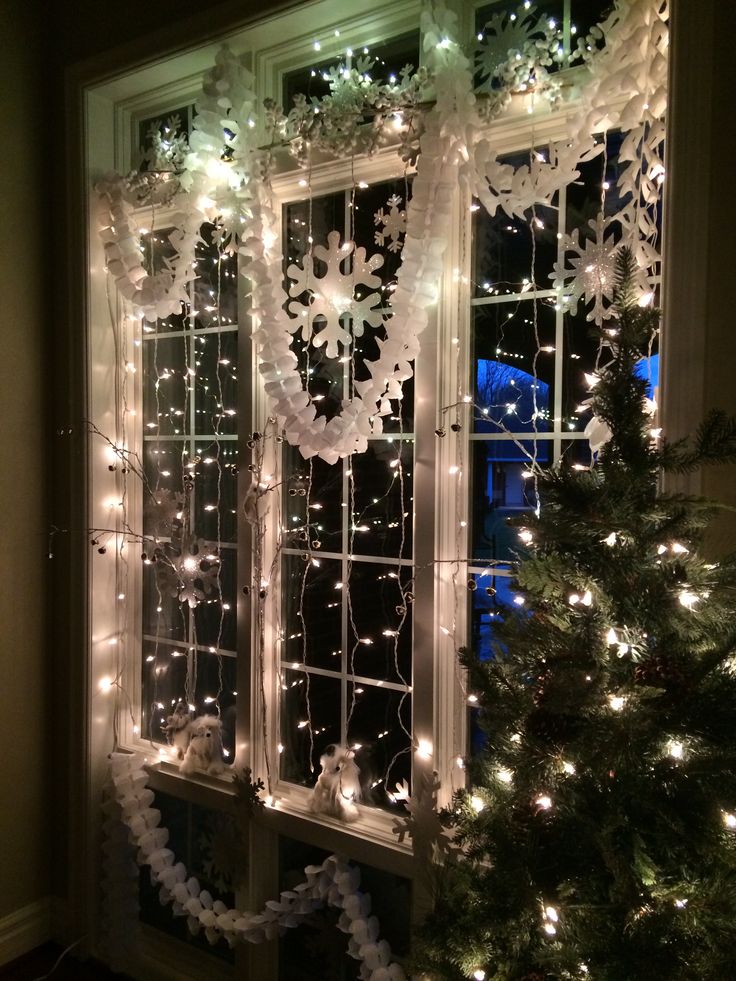 a christmas tree in front of a window