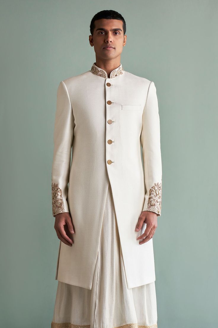 Ivory silk sherwani with floral embroidered band collar, cuffs and designer buttons. Comes with anarkali kurta, churidar and lucknowi stole. 
Component: 4
Embroidered
Neckline: Band Collar
Sleeve Length: Full
Fabric: Sherwani: Silk; Kurta: Silk Georgette; Churidar: Cotton Silk; Stole: Lucknowi
Color: White
Patch pocket
Cutaway sherwani
Anarkali kurta with embroidered border
Embroidered stole - Aza Fashions White Sherwani, Sabyasachi Collection, Designer Buttons, Anarkali Kurta, Silk Kurta, White Patches, Embroidered Border, Ivory Silk, Embroidered Neckline