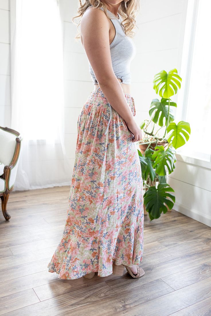 Look no further, our best-selling maxi skirt is here in a fresh new print! The stunning bright floral print, flattering button detail, and a flowy maxi-length is sure to make this your go-to for any summer get-together! Whether you’re heading out on a flirty date night or a daytime gathering, the only thing you’ll be worried about is having too much fun! Features: smocked elastic waist, functional buttons, lined to knee, floral print, open in front, long length Color: Blush Mix100% RayonFor full care instructions, please refer to the manufacturer's label. Fit: True to size.Length: Hits at the ankle on most -- 42” in total lengthWaist: Stretchy with elastic waistbandHips: Relaxed with give Models are wearing size Medium and Small respectively. MODEL INFO Ashley Brook Height: 5'3" Height: 5' Play Date, Floral Maxi Skirt, Color Blush, New Print, Floral Maxi, Button Detail, Long Length, Date Night, Smocking