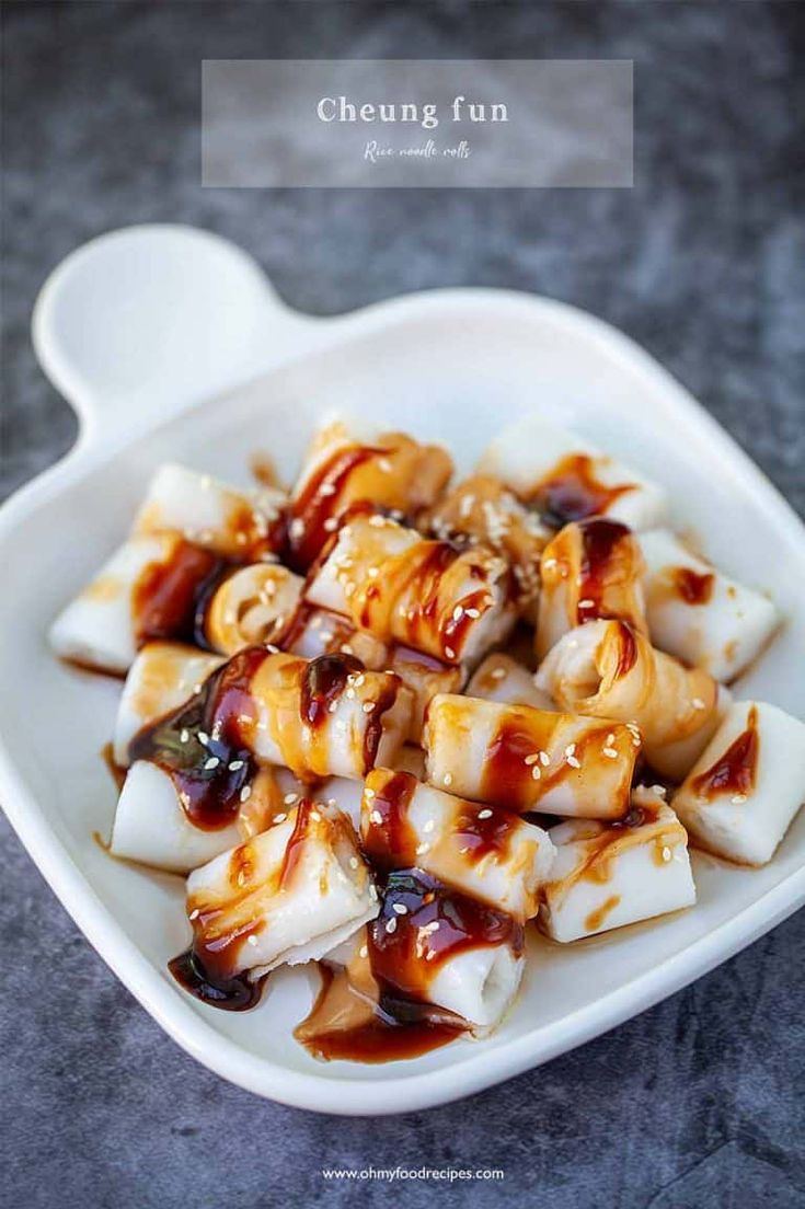 a white plate topped with dumplings covered in sauce