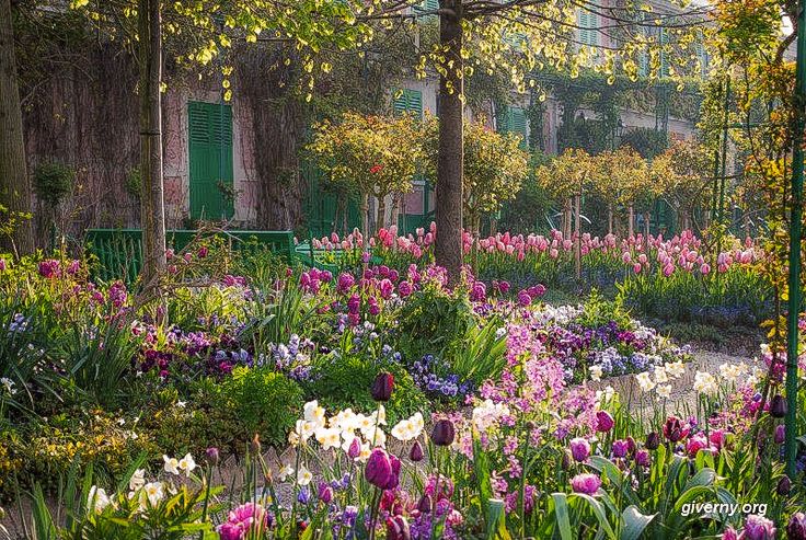 the garden is full of colorful flowers and trees