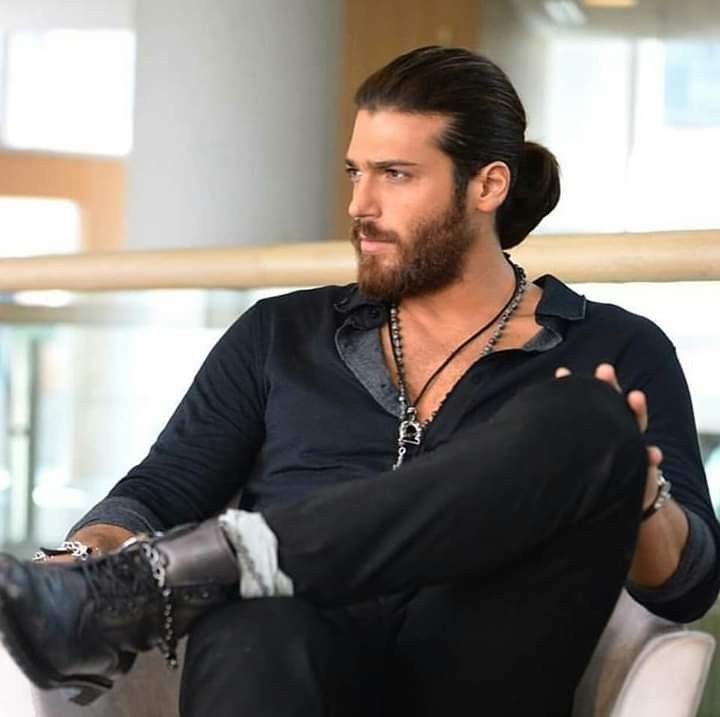 a man sitting on top of a white chair