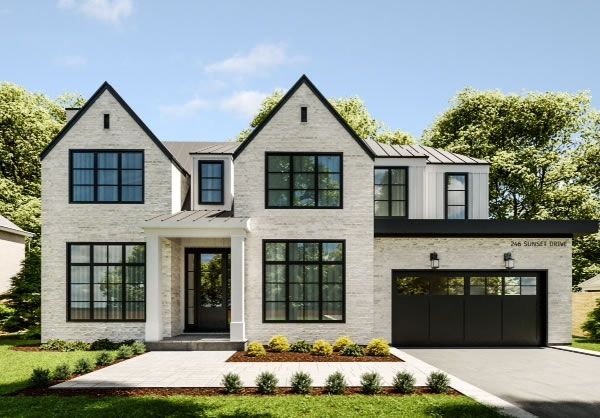 a large white brick house with black garage doors and windows on the front side of it