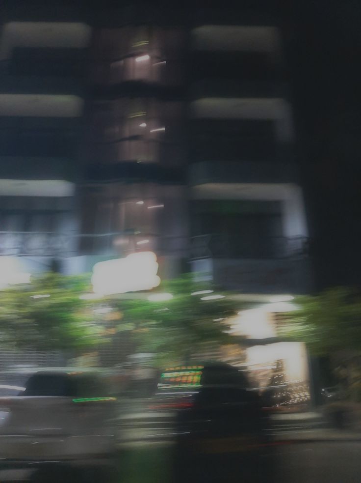 blurry photograph of an apartment building at night