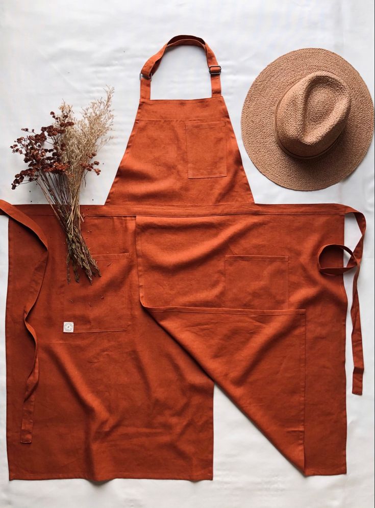 an orange apron and hat sitting on top of a table