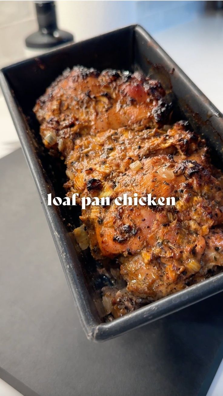 a pan filled with meat sitting on top of a table