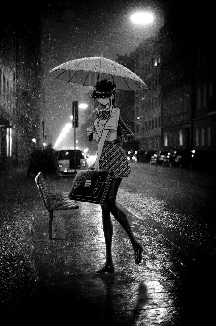 a woman walking down the street in the rain with an umbrella over her head and purse