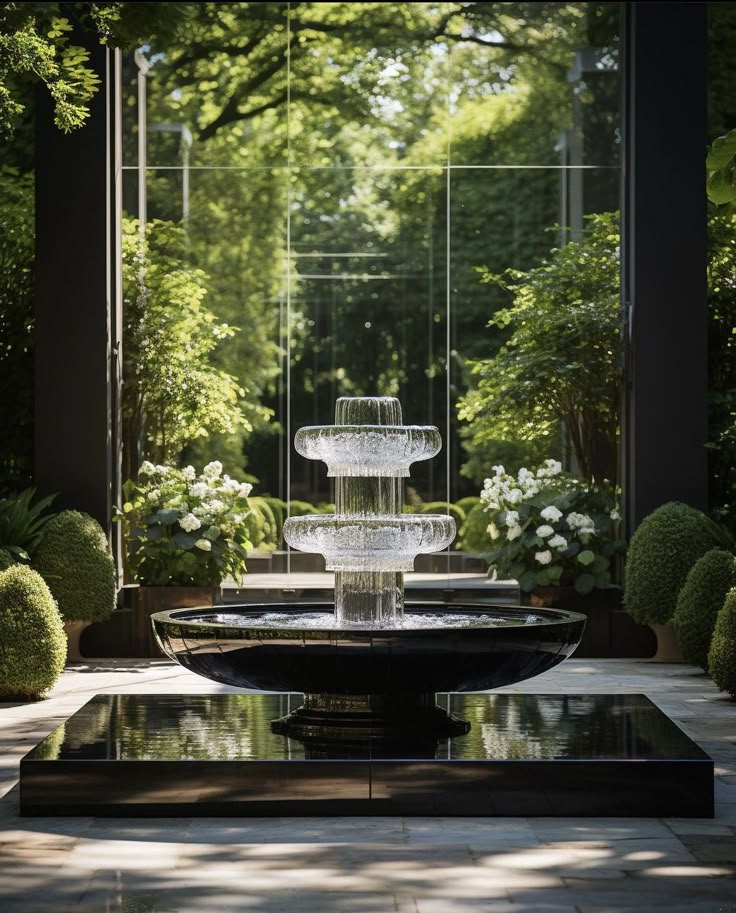 a water fountain surrounded by trees and bushes