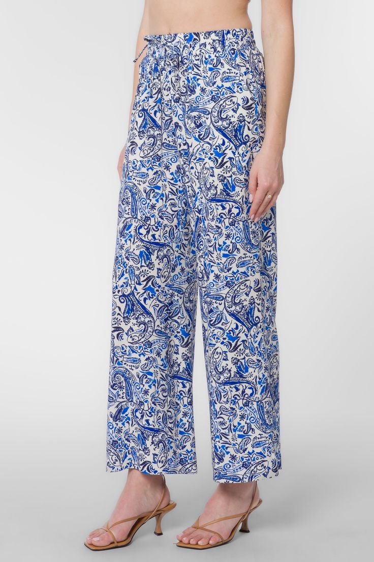 Looking for a fresh and fashion-forward look? These stylish pants feature a pull-on style, wide legs, an elastic drawstring waist, and side pockets. So whether you're dressing up or dressing down, these pants are sure to keep you looking your best. Material: 100% Viscose Machine wash cold, tumble dry low Color: Blue Paisley Model is 5'9" and wearing a size S Imported Summer Wide-leg Paisley Print Pants, Paisley Print Vacation Bottoms, Vacation Paisley Print Long Pants, Paisley Print Long Pants For Vacation, Blue Paisley Print Bottoms For Vacation, Paisley Print Blue Bottoms For Vacation, Spring Paisley Print Trousers, Paisley Print Trousers For Spring, Spring Wide Leg Bottoms With Paisley Print