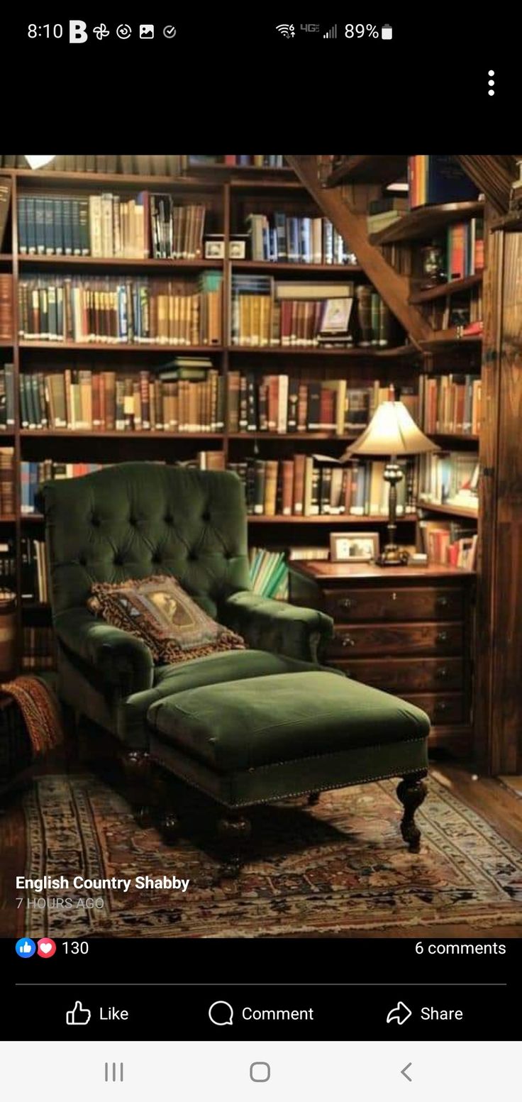 a green chair sitting in front of a bookshelf