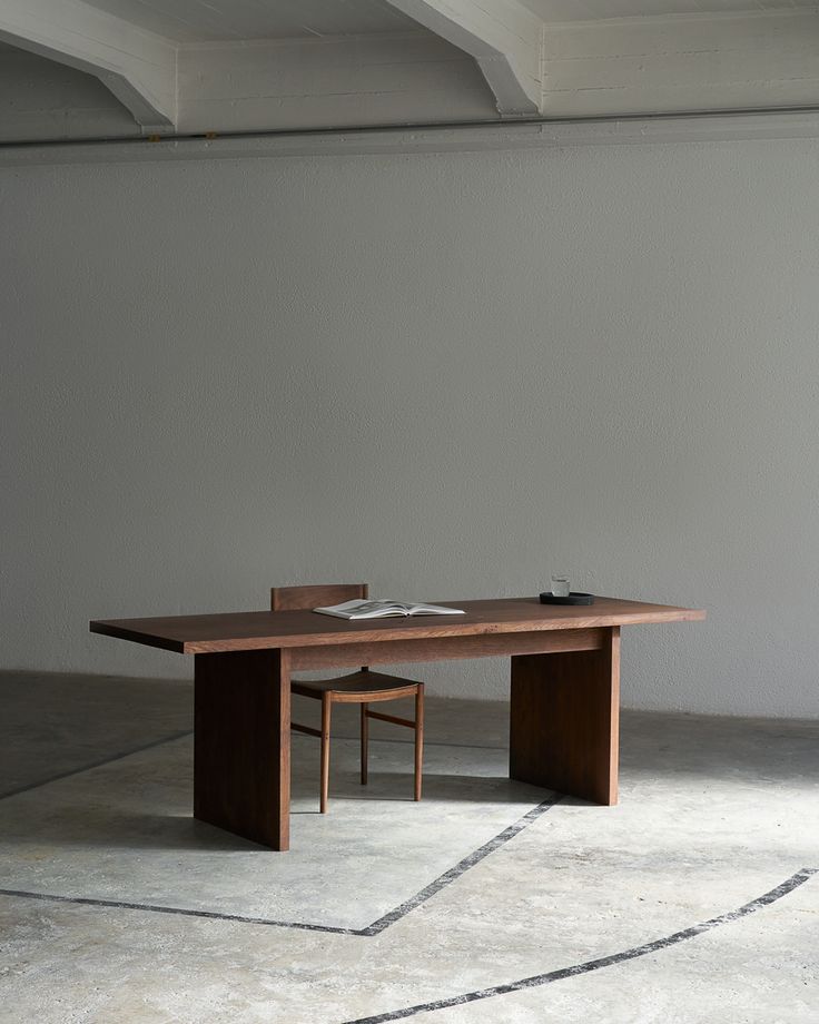 a wooden table sitting on top of a cement floor