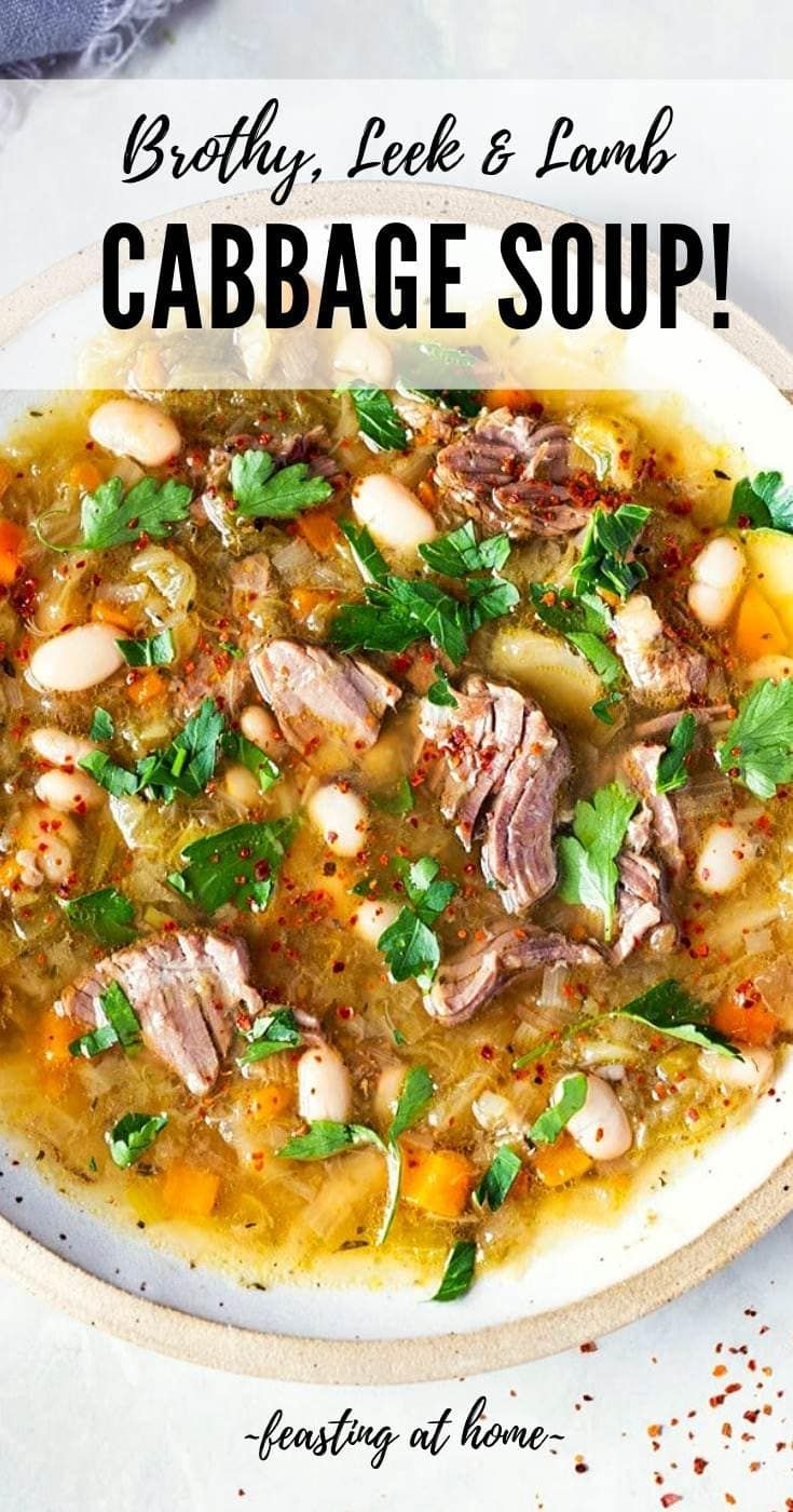 a white plate topped with meat and vegetables next to a bowl of soup on top of a table