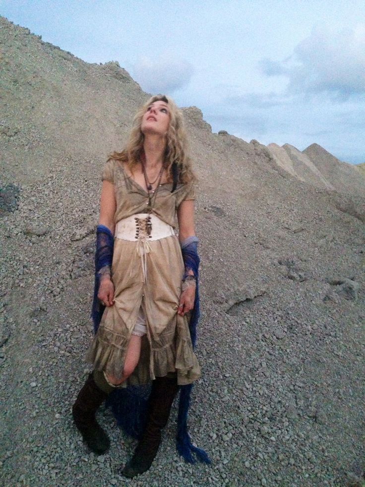 a woman laying on top of a pile of rocks