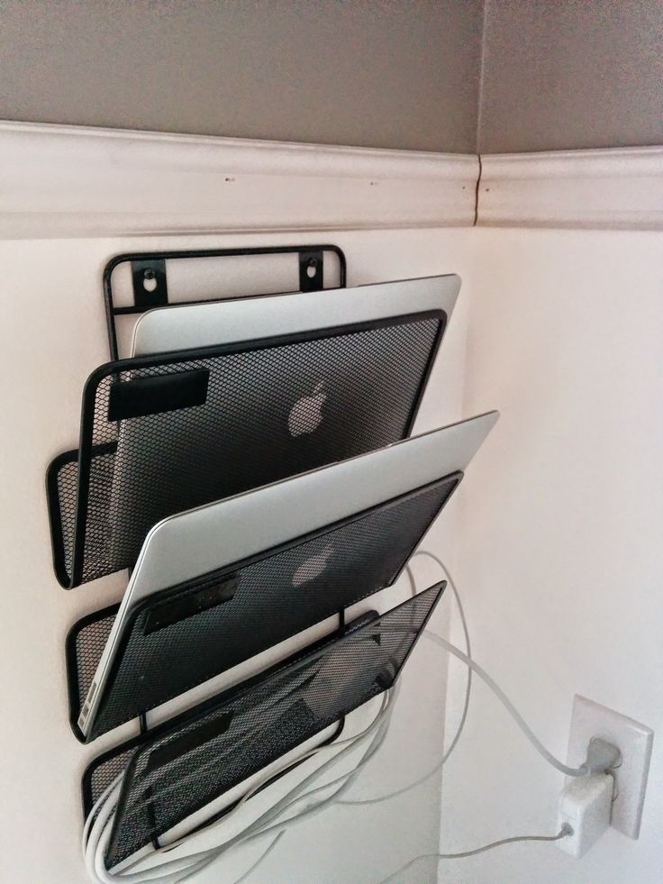 there are three laptops that are on the wall